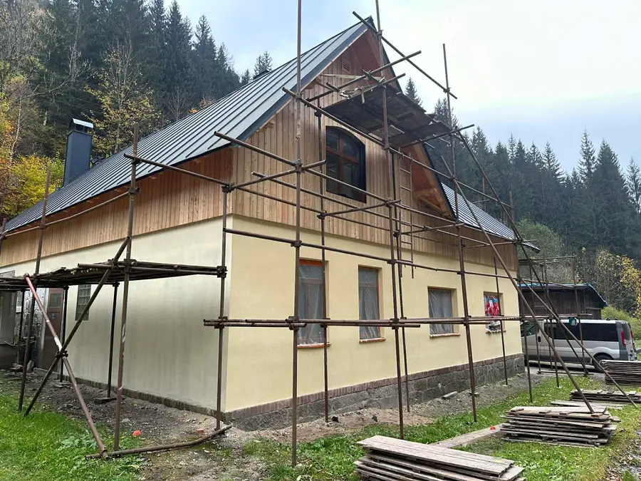 Dřevěný dům na klíč na lešení, montáž fasády a plechové střechy